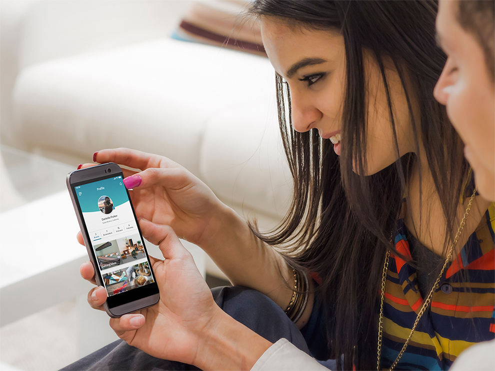 woman being shown the app from a friend